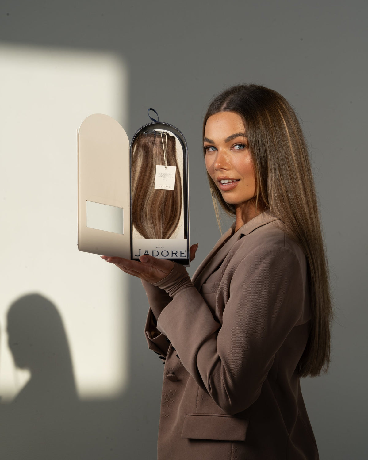 Model holding a Jadore Hair Supplies extension box