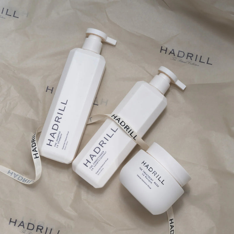 Hadrill Ritual Trio (unboxed) shampoo, conditioner and treatment mask on branded tissue paper with ribbon.